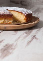 Sponge cake of lemon over wooden background