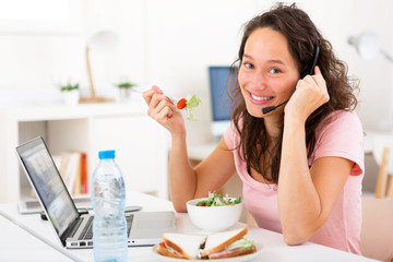 Young attractive student salad sandwich while working