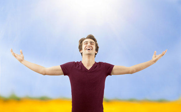 Young Man Spreading Arms In Nature