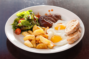 steak with eggs and vegetables