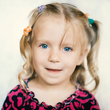 Cute little girl over bright background. Color toned image.