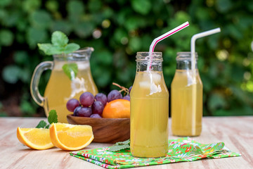 Fresh iced drinks with grapes and orange