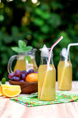 Fresh iced drinks with grapes and orange