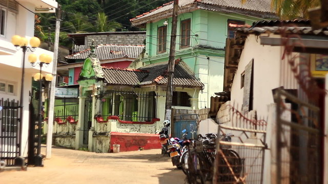 Hambantota, Asia, Sri Lanka, in November 2013. Poor neighborhoods. Bright colors of the buildings, interesting architecture. Traffic on the narrow streets.