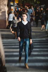 Young man cross the street