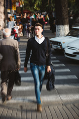 Young man cross the street