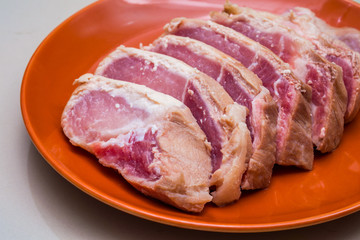 Raw sliced pork in the orange dish - Ingredient