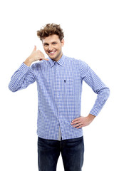 Young casual man showing call me gesture, Communicati on