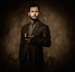 Handsome well-dressed with glass of beverage