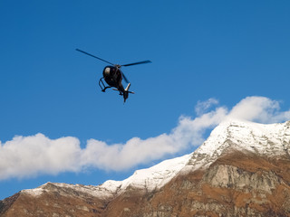 Naklejka na ściany i meble flying elicopter by the dam