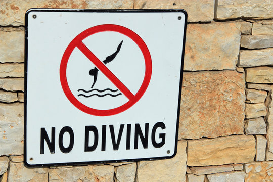 Sign for no diving symbolizing danger, safety and vacations