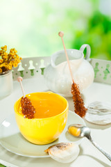 cup of tea with sugar candy on a tray