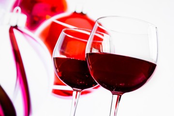 two red wine glasses against christmas decoration background