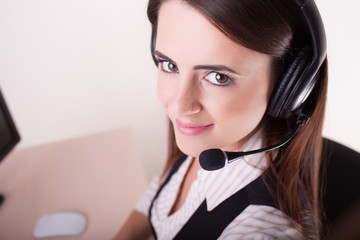 Female customer support operator with headset and smiling