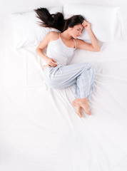 Obraz na płótnie Canvas Woman sleeping in open fetal position
