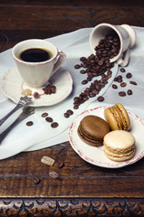 Coffee mood: cup of coffee, coffee beans and macaroons