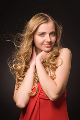 Portrait of beautiful young blonde in red dress
