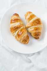 delicious breakfast with croissants in bed