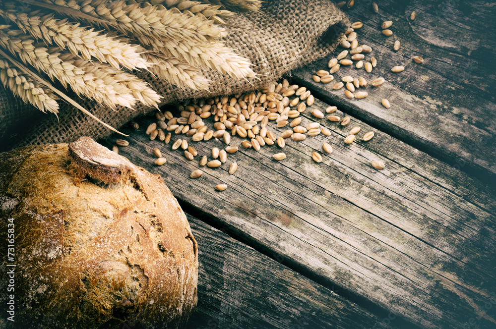 Wall mural fresh loaf of bread and wheat