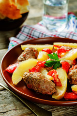 meat cutlets baked with potatoes, tomatoes and red pepper