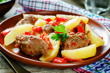 meat cutlets baked with potatoes, tomatoes and red pepper