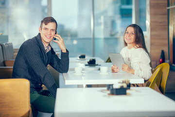 couple in cafe using digital tablet and phone, selective focus