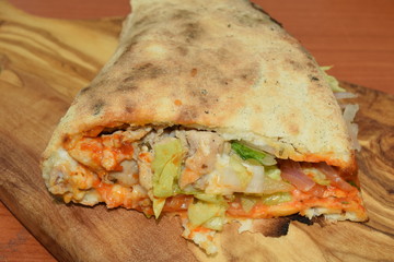 Chicken sandwitch on a wooden plate