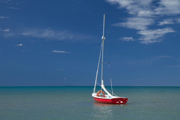 Alone red and white boat at the sea (Vertically)