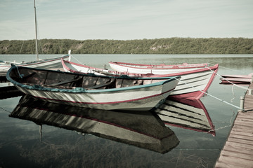 Fototapeta na wymiar Floating Wooden Boat with Paddles