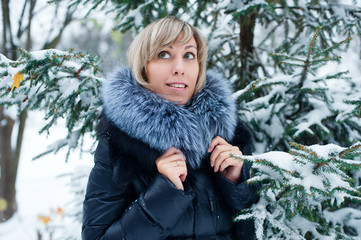 portrait of a girl on the street in winter with snow