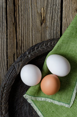 Three eggs in a rustic bowl