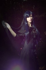 The beautiful woman in Gothic style in the forest