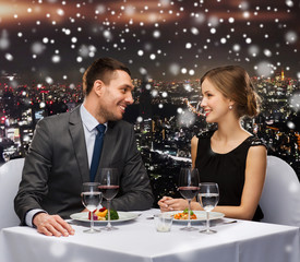 smiling couple eating main course at restaurant