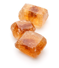 Brown caramelized lump cane sugar cube isolated on white backgro