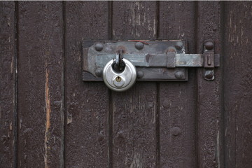 Padlock hanging at a gate