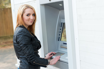 Fototapeta na wymiar Sexy girl at ATM