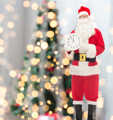 man in costume of santa claus with clock