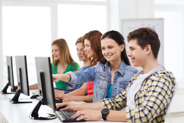 male student with classmates in computer class