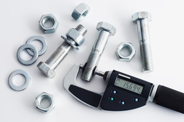 Measurement of steel bolts. Measuring with digital micrometer.