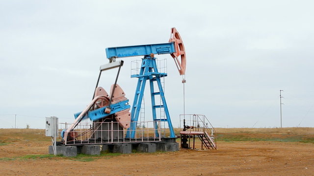 Work of oil pump jack on a oil field.