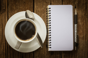 Obraz na płótnie Canvas Black coffee with notebook