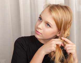 Blond Caucasian girl braids plait, closeup  portrait