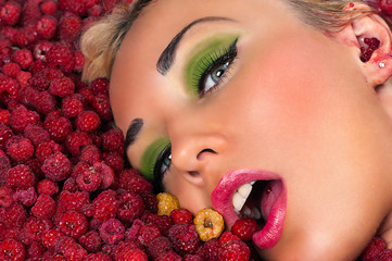 beautiful woman face in raspberries