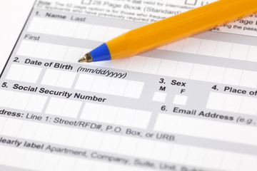 Application form with ballpoint pen.