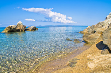 Sandy beach with rocks near greek village Toroni in Sithonia