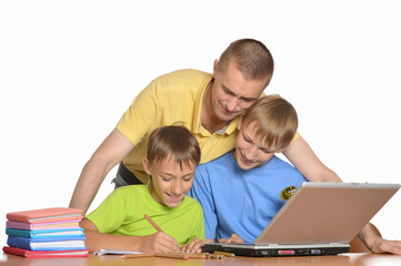 Father is helping kids with homework