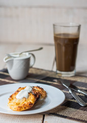 cottage cheese pancakes with sour cream and coffee, breakfast