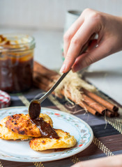 cottage cheese pancakes with condensed milk and coffee, hands