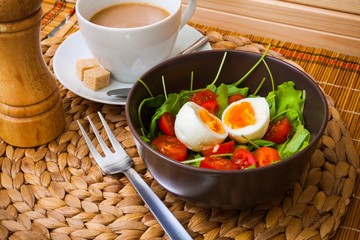 Arugula salad with tomatoes, egg, coffee