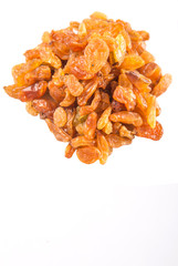 Dried orange colored raisin over white background
